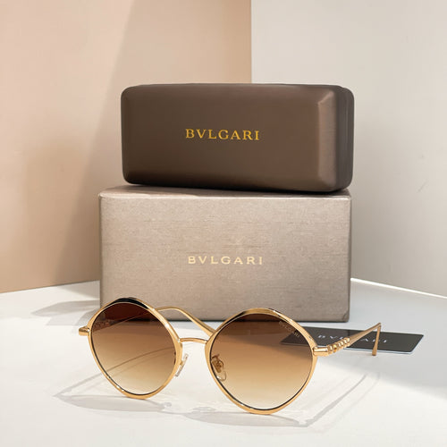 Gold round sunglasses with amber-tinted lenses and slim metal arms.