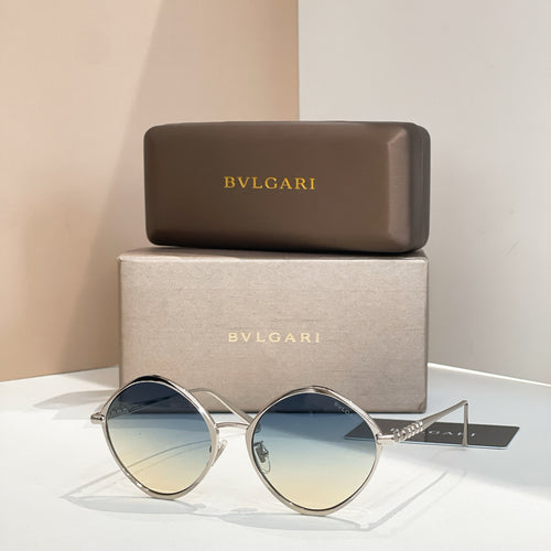 Silver round sunglasses with blue-tinted lenses and slim metal arms.