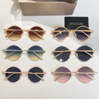 Assorted round sunglasses with gold and silver frames and tinted lenses.