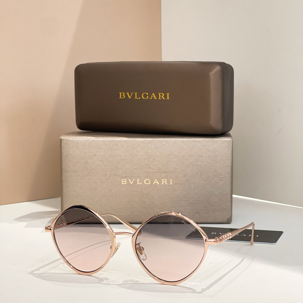Rose gold round sunglasses with gray-tinted lenses and thin metal arms.