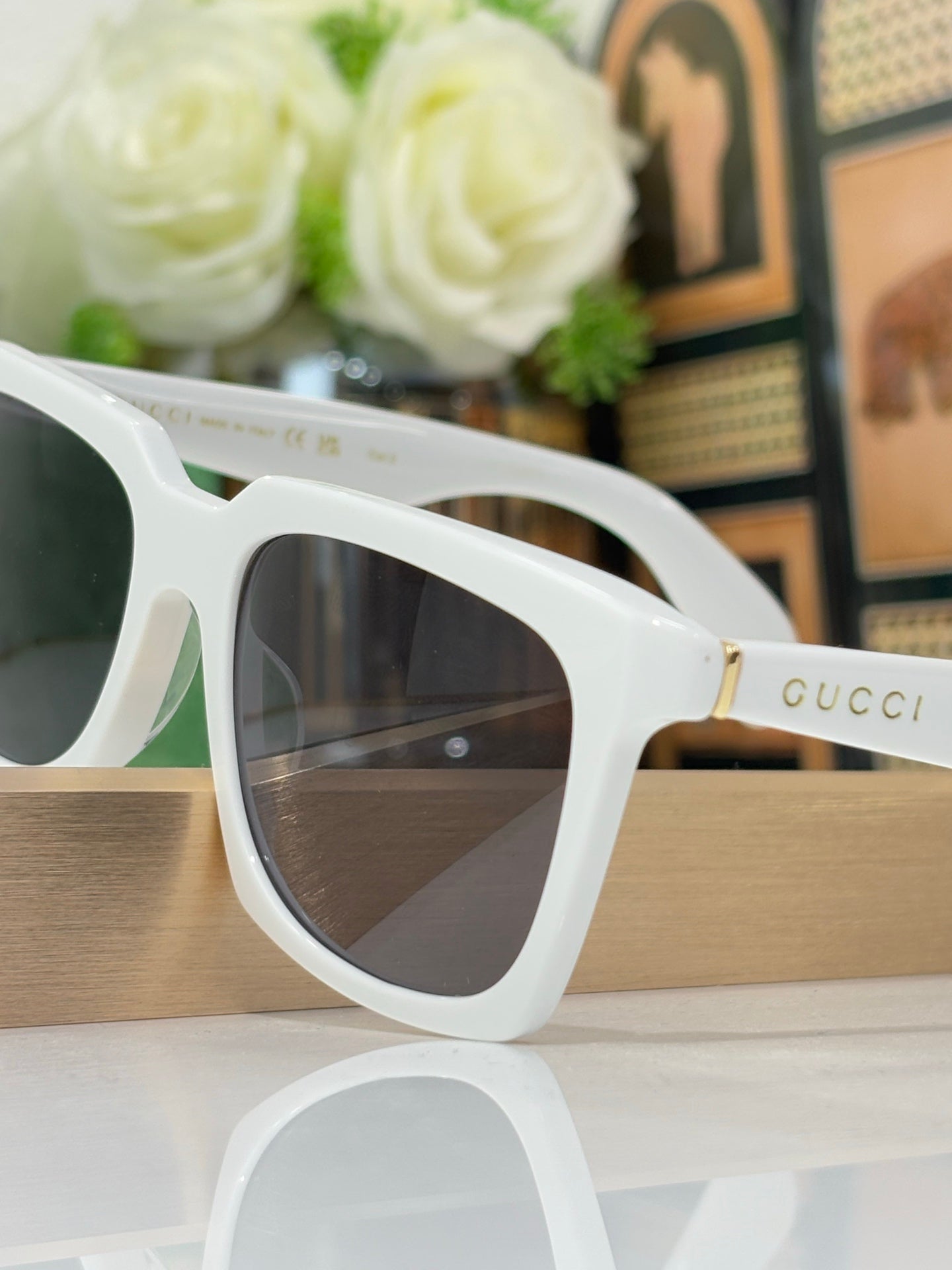 White Gucci square sunglasses close-up with dark tinted lenses