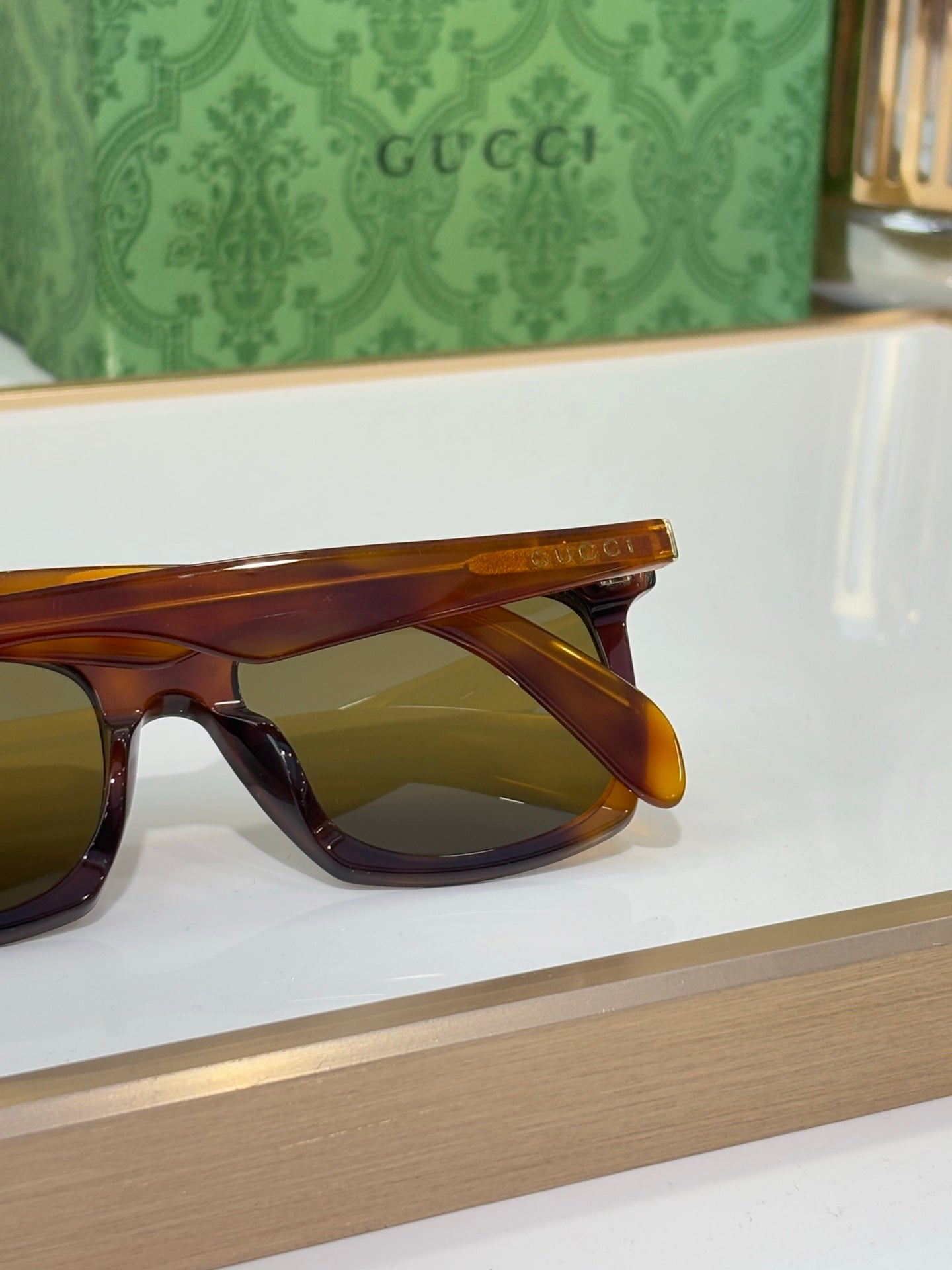 Tortoise Gucci sunglasses side close-up with amber tinted lenses