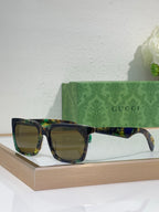 Multicolor Gucci square sunglasses with green tinted lenses and glossy frames