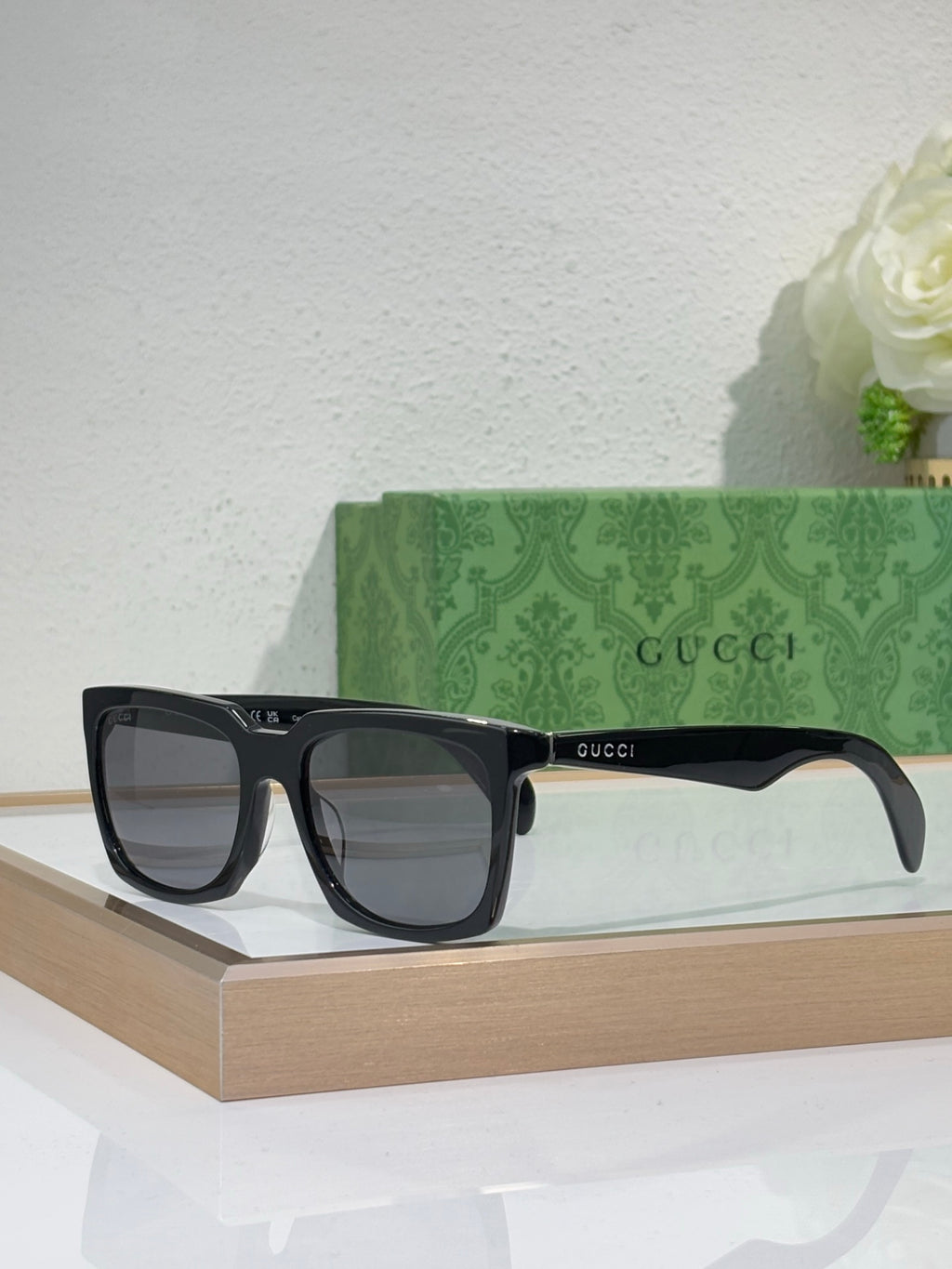 Black Gucci square sunglasses with thick frames and dark tinted lenses