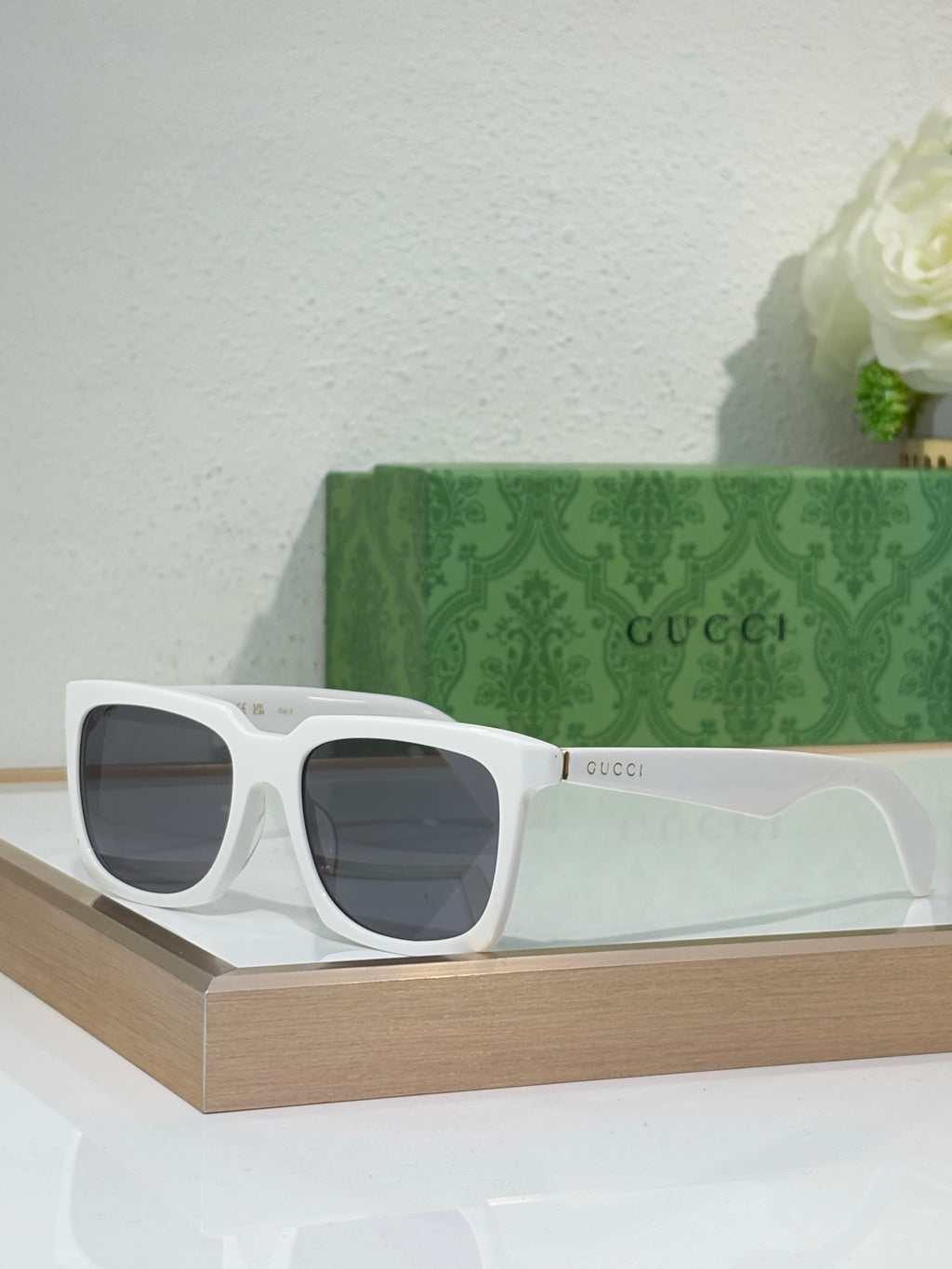 White Gucci square sunglasses with thick frames and dark tinted lenses