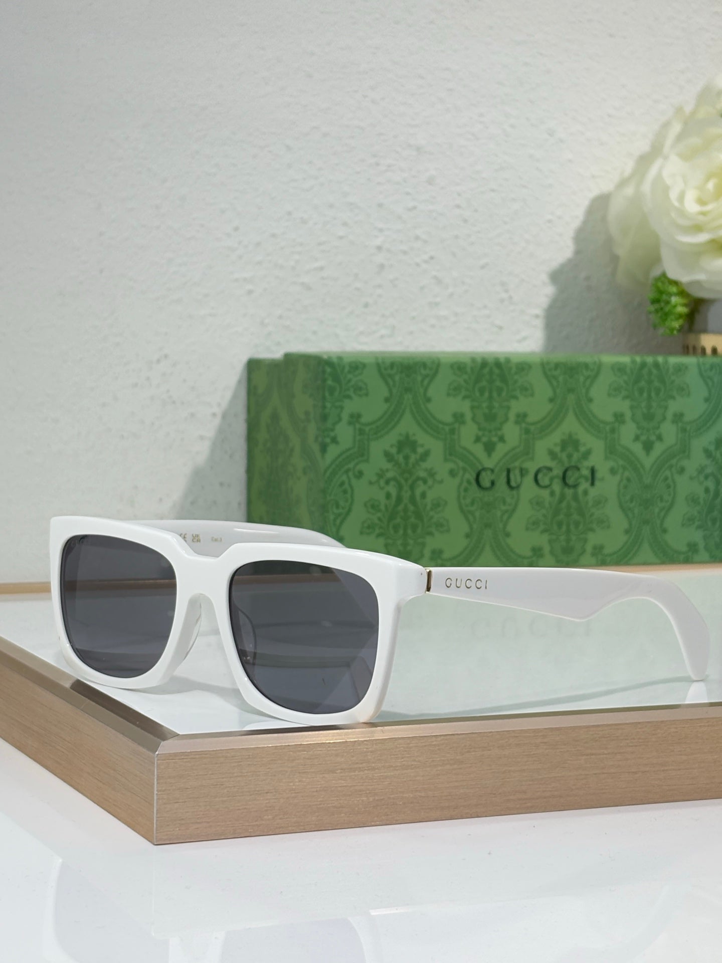 White Gucci square sunglasses with thick frames and dark tinted lenses