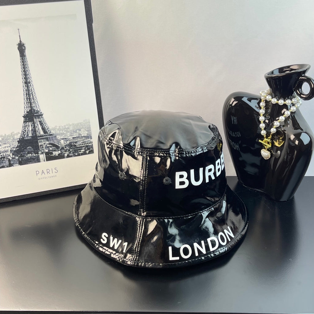 Glossy black bucket hat with Burberry logo text and London detail