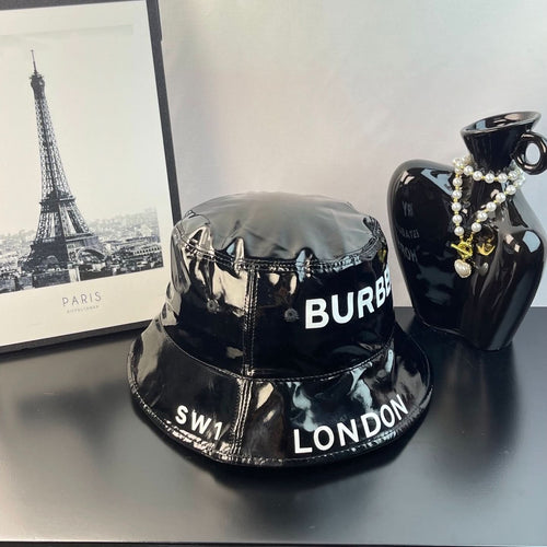 Glossy black bucket hat with Burberry logo text and London detail