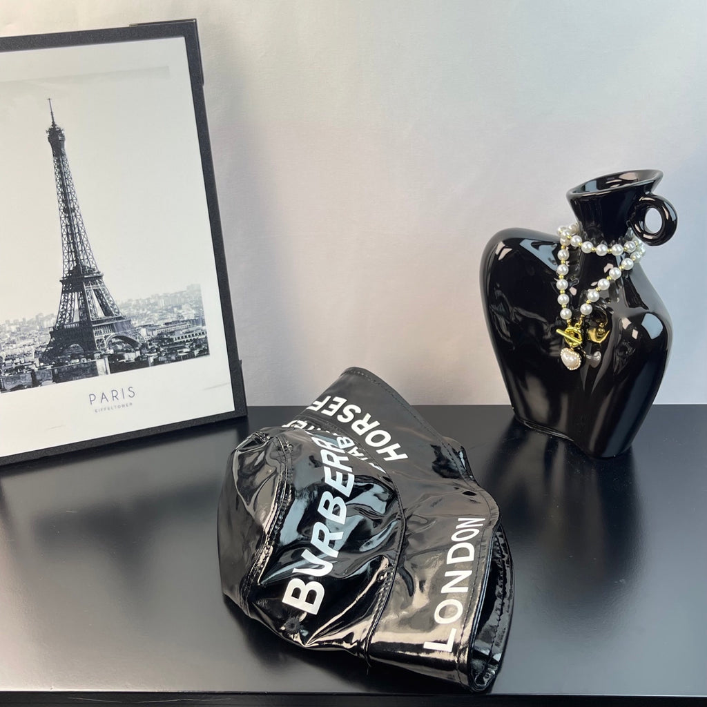 Folded glossy black bucket hat with Burberry and London print