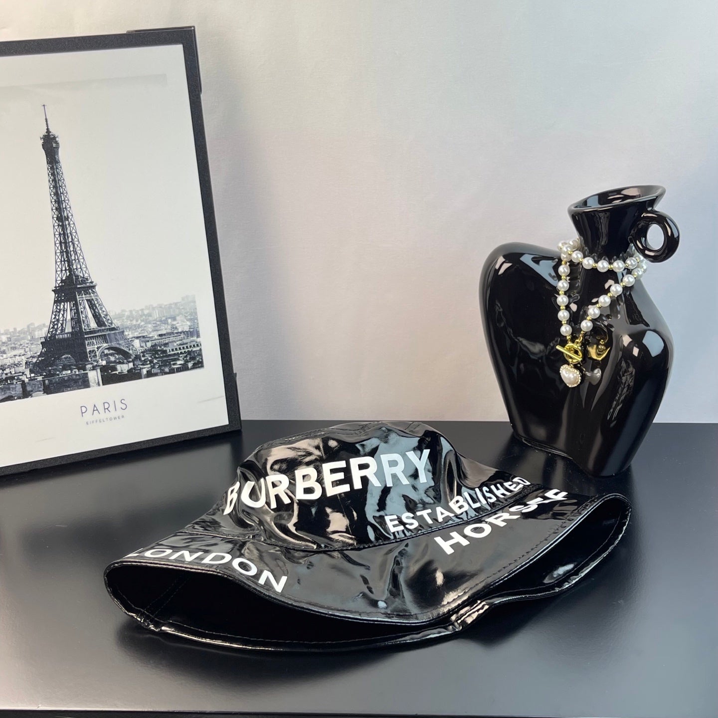 Glossy black bucket hat with brim text Burberry and London, side view