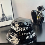 Glossy black bucket hat with Burberry and Establish Horse lettering