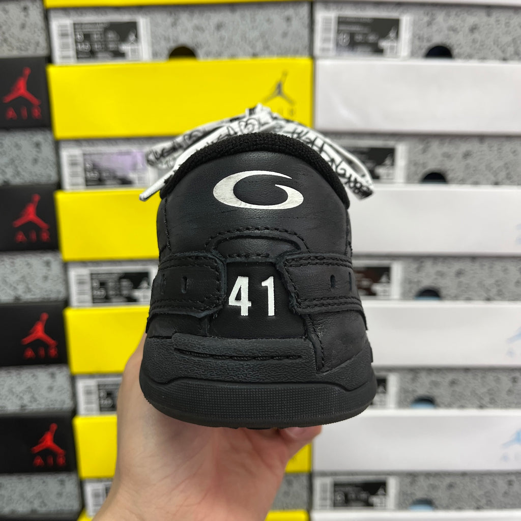 Black sneaker heel view with size 41 marking on back tab