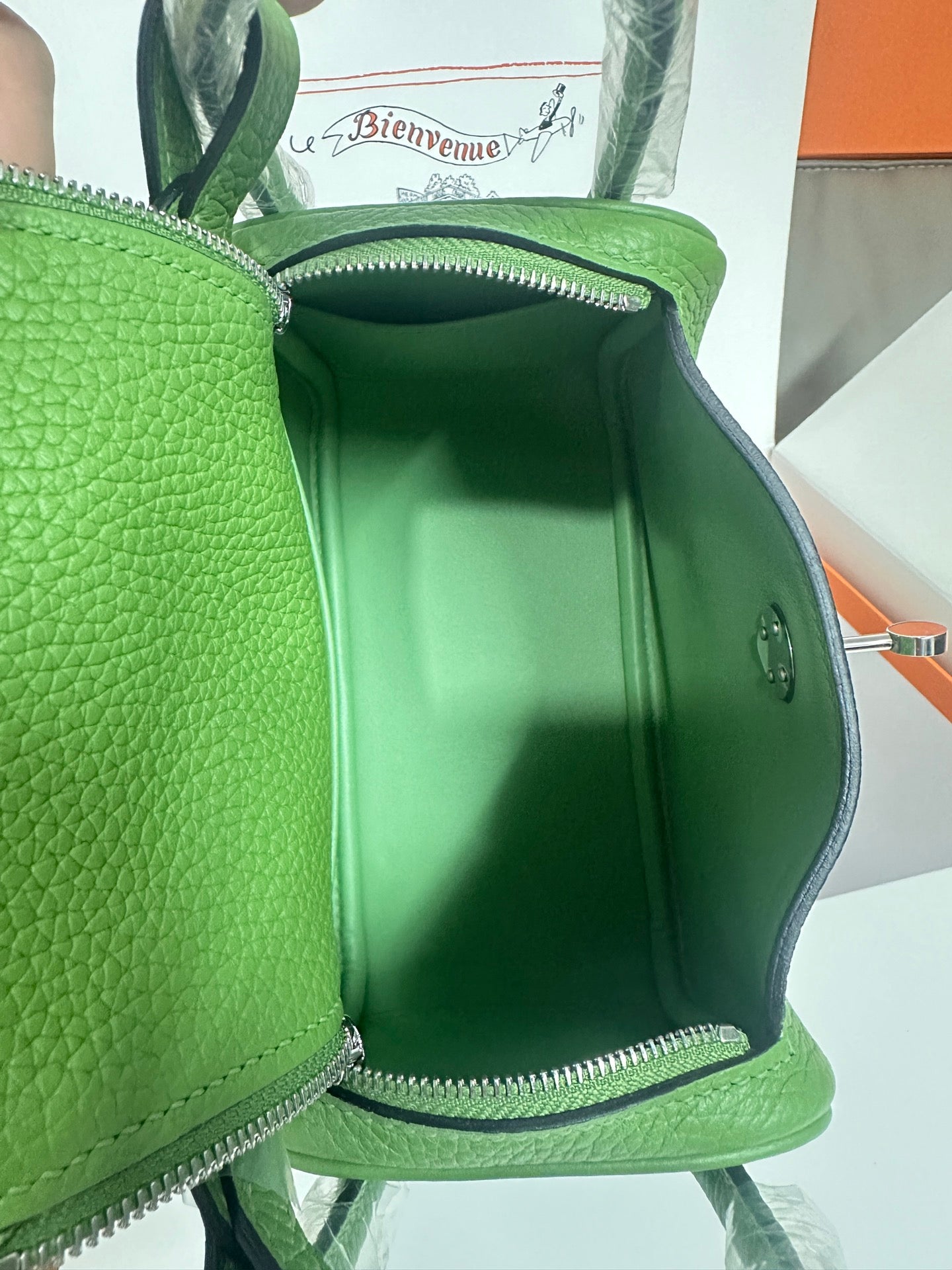 Green leather Hermes handbag interior close-up with side wall and zipper pocket