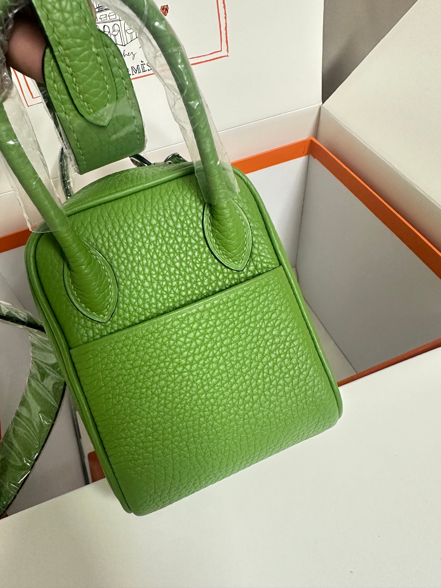 Green textured leather Hermes handbag with two top handles and front flap pocket