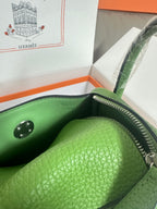 Green leather Hermes handbag with open top, visible interior lining and silver zipper