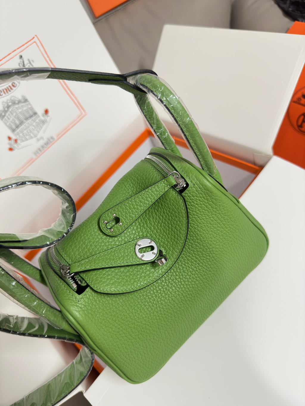 Green textured leather Hermes handbag with front pocket flap, top handle, silver hardware