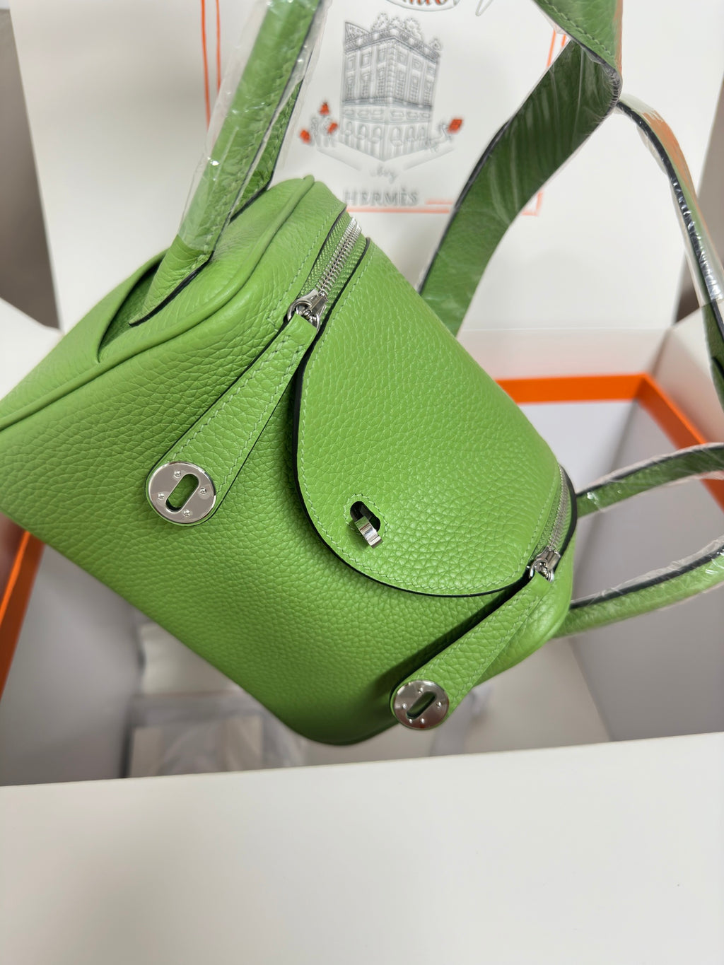 Green leather Hermes handbag with front flap pocket and shoulder strap, silver hardware