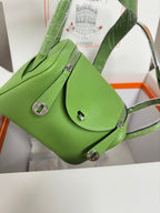 Green leather Hermes handbag with front flap pocket and shoulder strap, silver hardware
