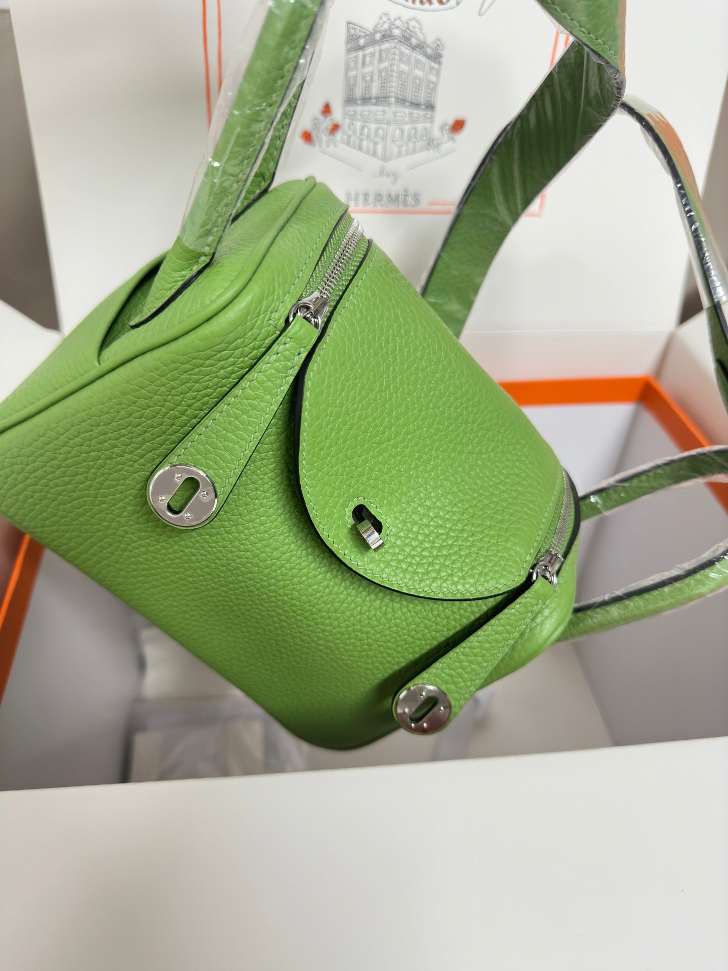 Green leather Hermes handbag with front flap pocket and shoulder strap, silver hardware
