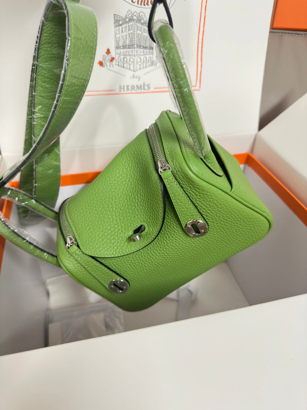 Green leather Hermes mini handbag with top handle and shoulder strap, silver hardware