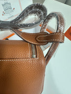 Hermes mini leather handbag strap and front flap detail in tan pebbled leather with stitching