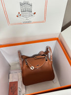 Hermes mini leather handbag in tan with top handle and front flap, silver hardware details