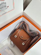Hermes mini leather handbag in tan with two top handles and front flap, silver-tone hardware