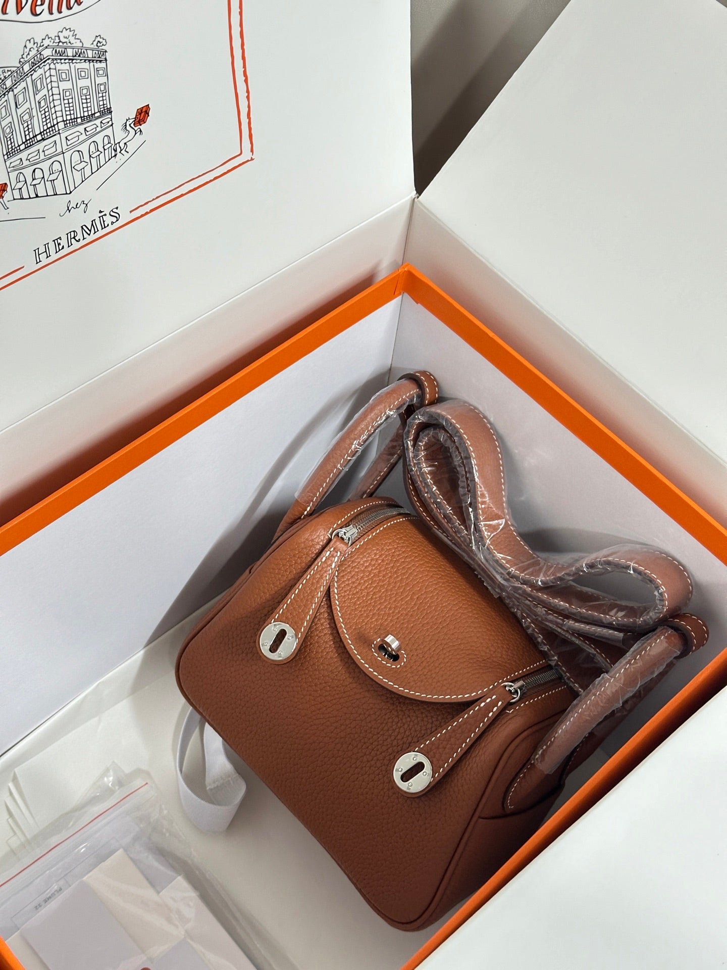Hermes mini leather handbag in tan with two top handles and front flap, silver-tone hardware