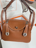 Hermes mini leather handbag in tan with front flap turn-lock and silver ring pulls