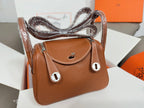 Hermes mini leather handbag in tan with top handle, front flap, and silver-tone hardware