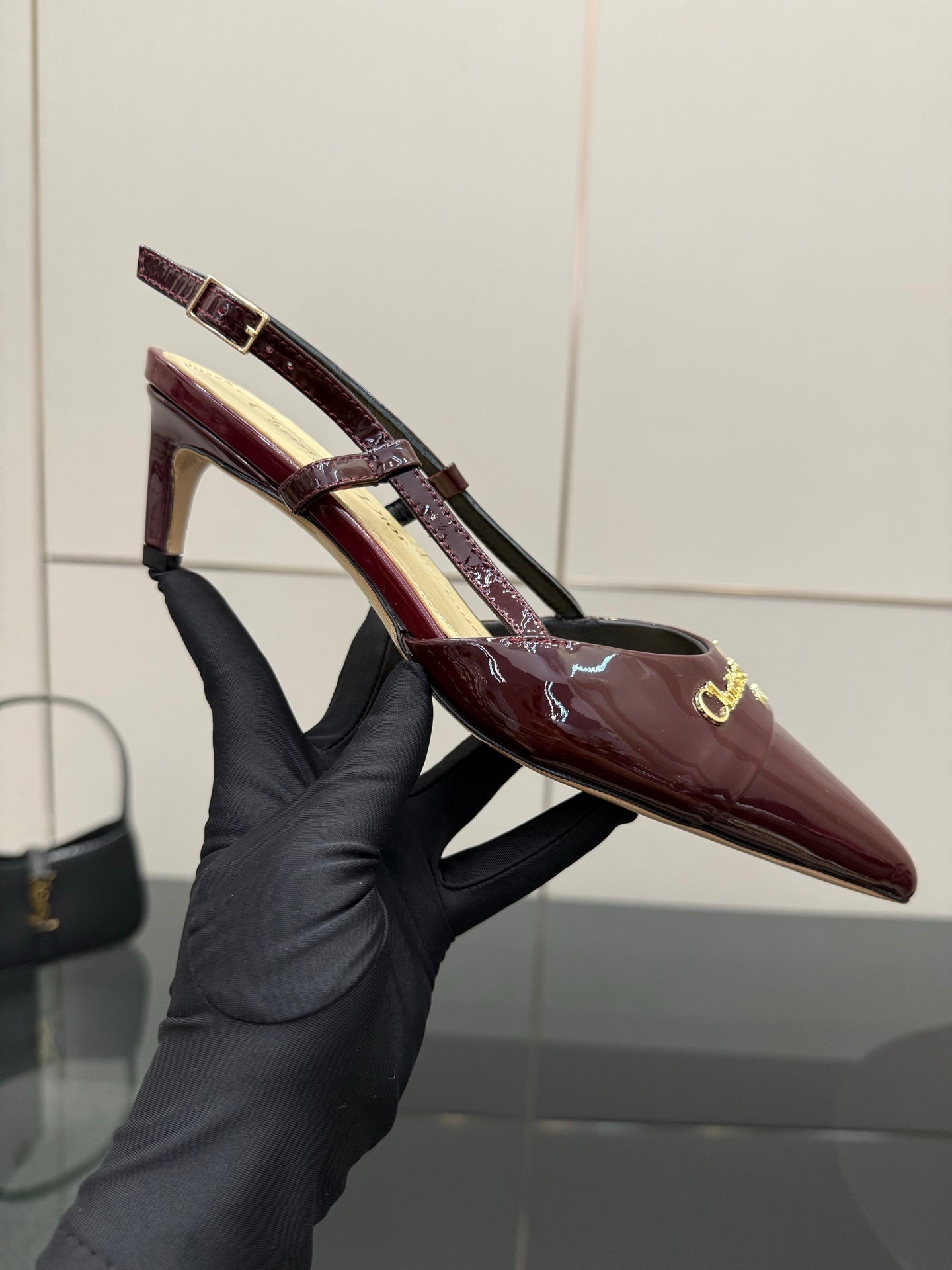 Ladies Dior burgundy patent slingback heel, pointed toe and gold logo detail