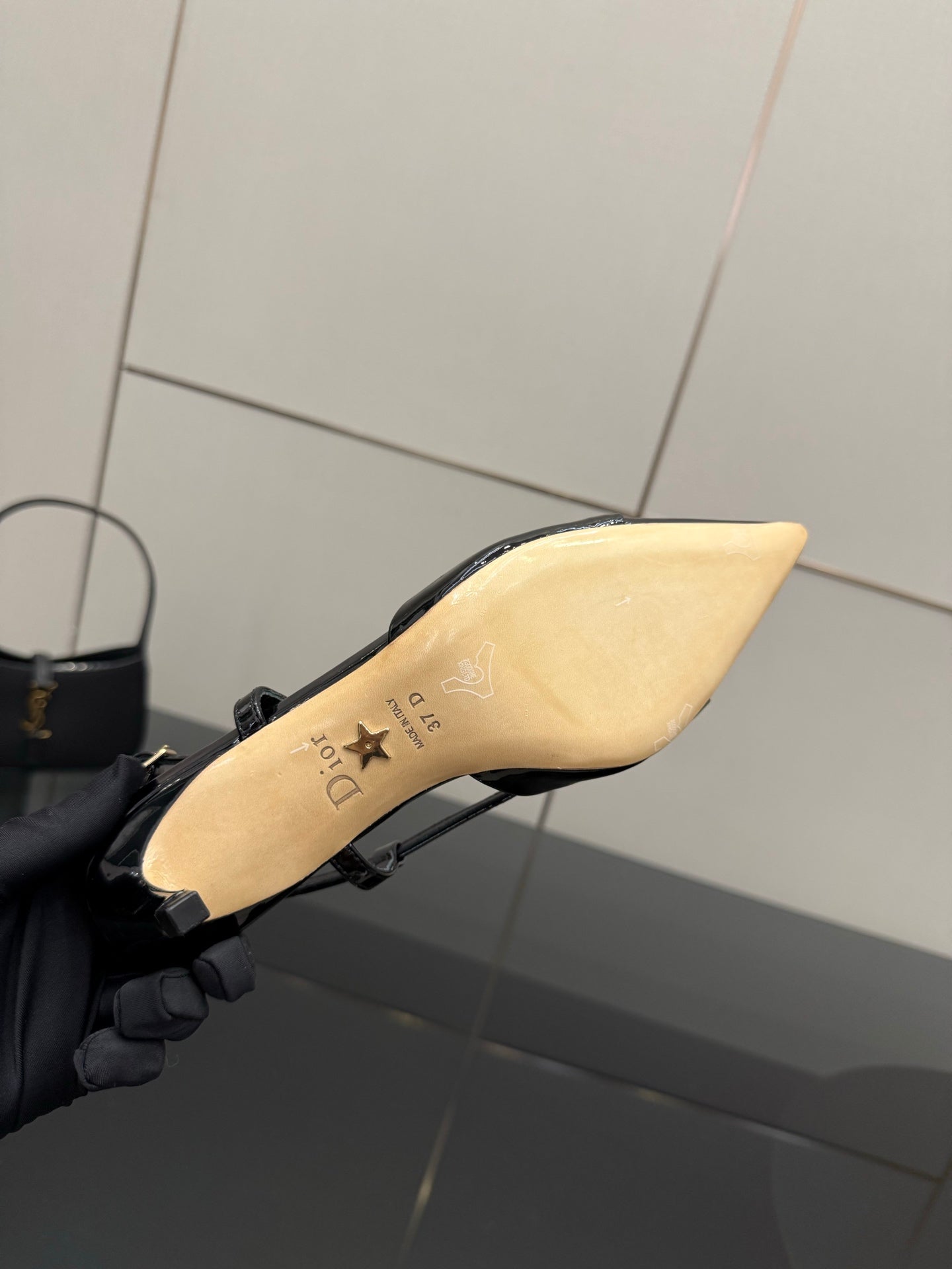 Black slingback heel sole with beige footbed and logo markings