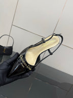 Black patent slingback with gold logo text and cream footbed