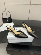 Pair of black slingback pumps, pointed toe, slim straps, beige insole visible