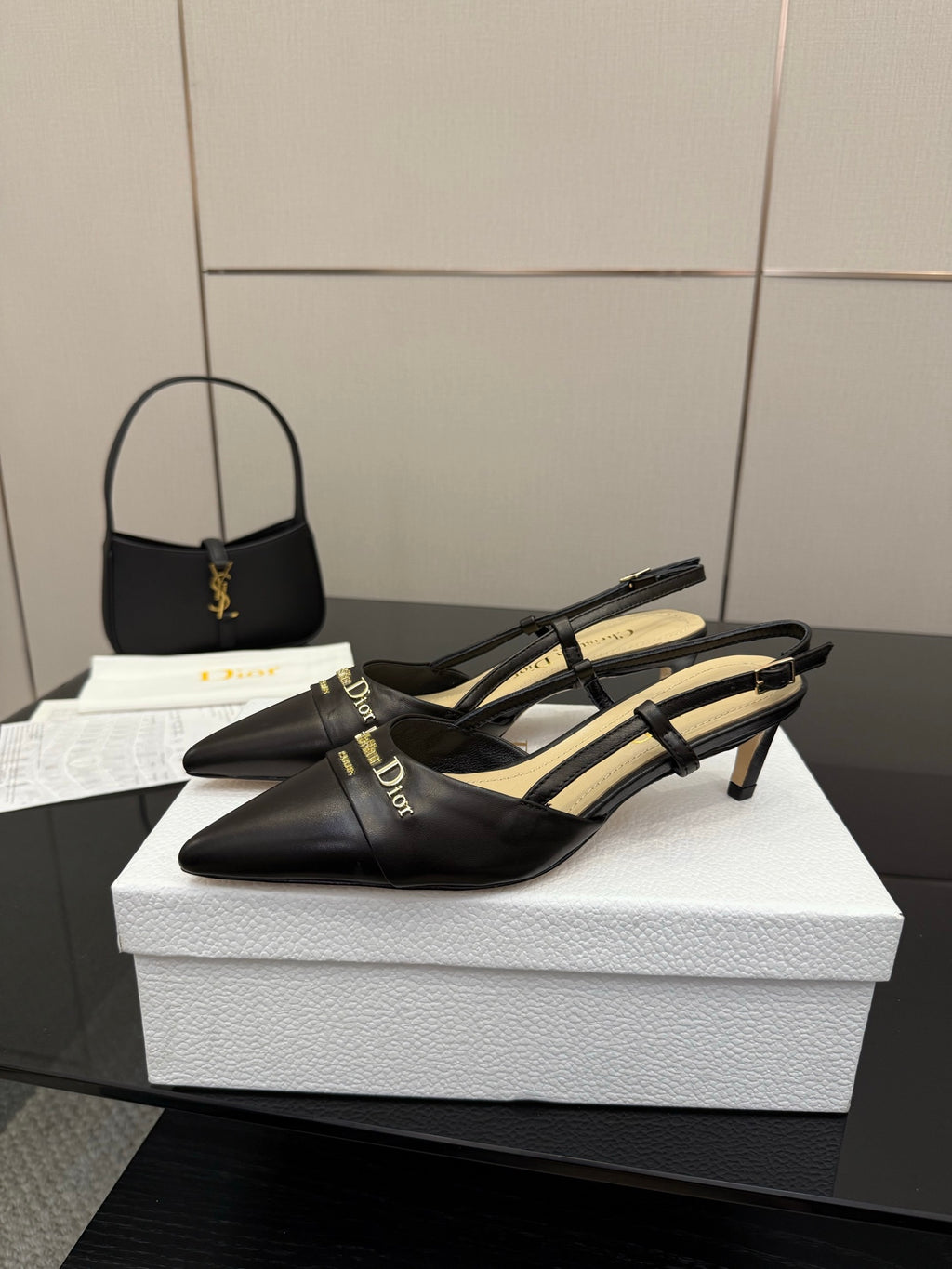Black leather slingback mules with block heel, pointed toe, gold logo detail