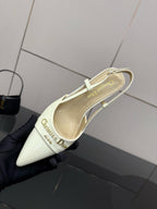Ivory pointed-toe slingback heel with ankle strap and printed insole text
