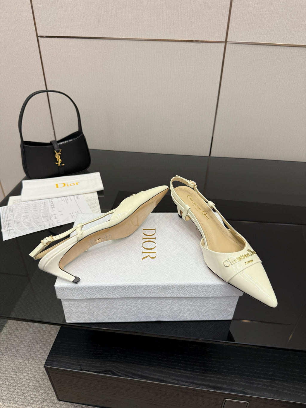 Ivory pointed-toe mule slingback heels with ankle strap and logo accents