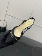 Black slingback heel showing cream insole and gold logo