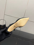 Black heel with light insole showing gold logo and star detail