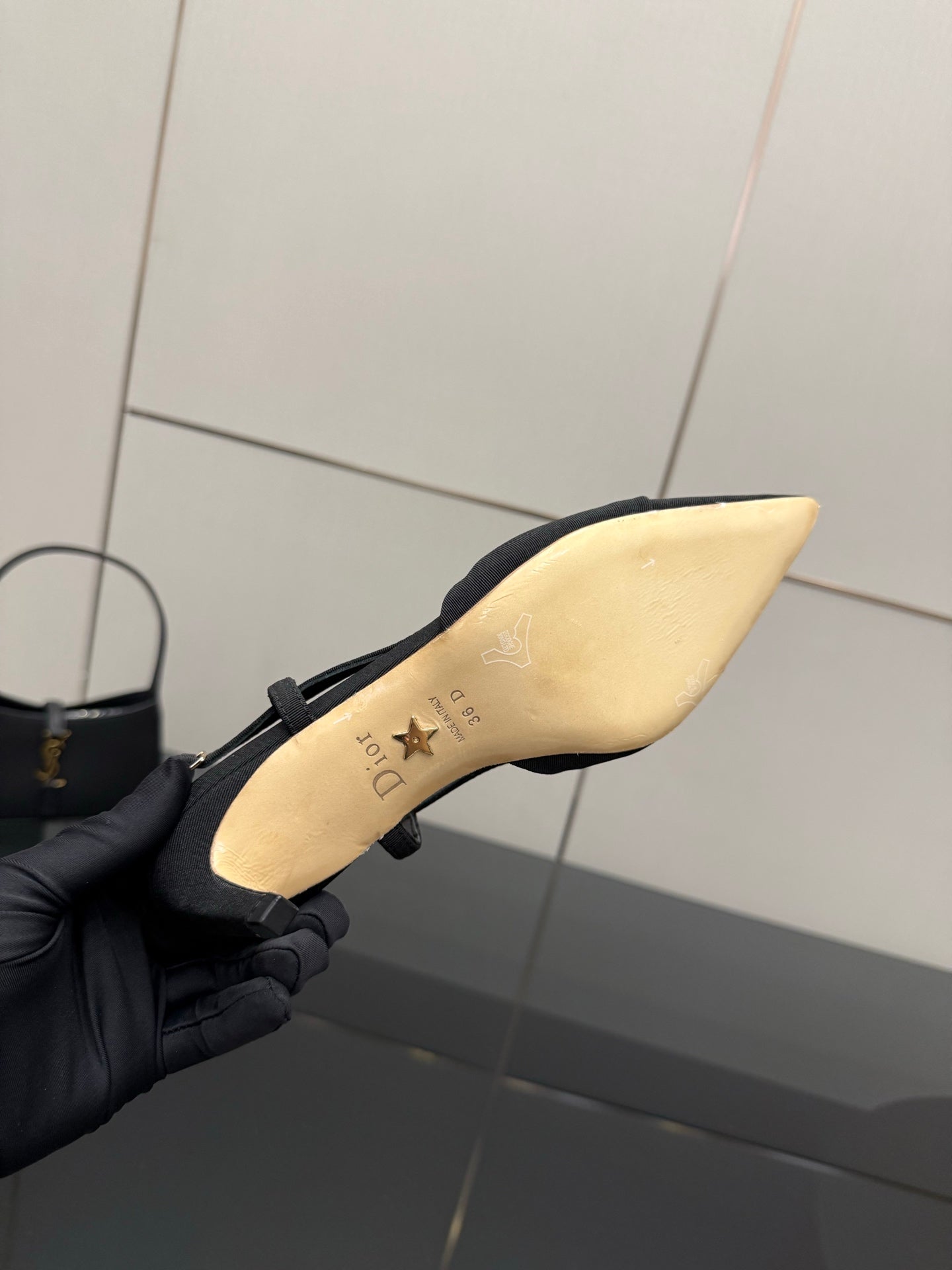 Black heel with light insole showing gold logo and star detail