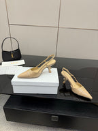 Beige point-toe slingback heels side view with covered heel and ankle strap