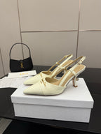 Ivory pointed-toe slingback heels with gold-tone stiletto heel and ankle strap