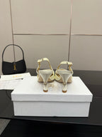Back view of ivory slingback pumps with thin ankle straps and stiletto heel