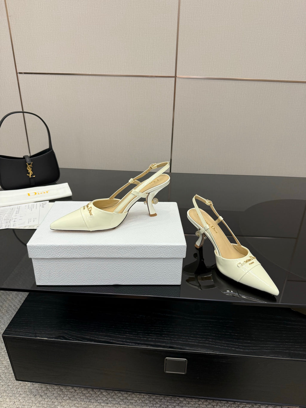 Ivory pointed-toe slingback pumps with gold-tone heels and ankle strap detail