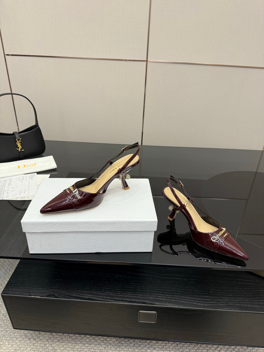 Dior ladies burgundy pointed-toe slingback heels, one shoe front on box.