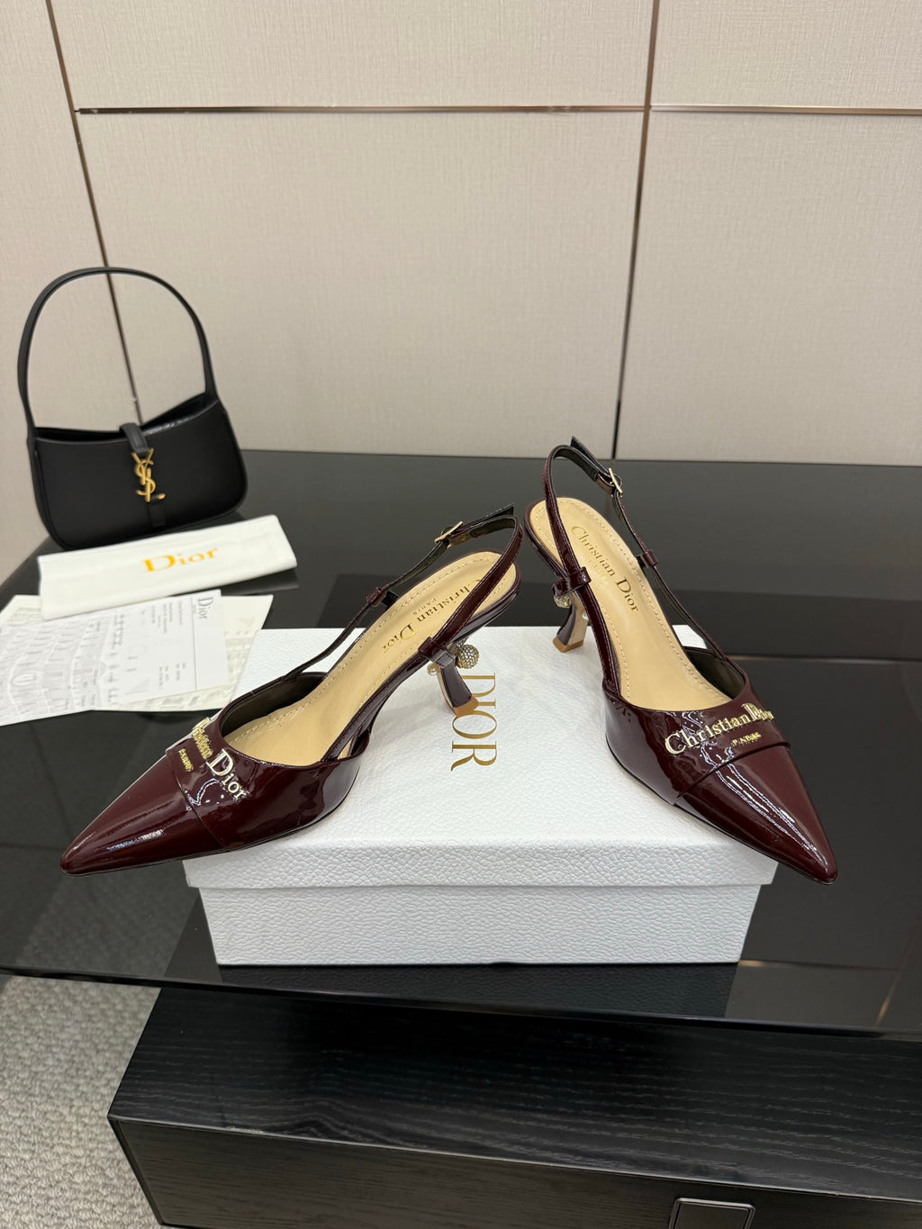 Dior ladies burgundy pointed-toe slingback heels shown at 3/4 angle.