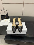 Black patent leather point-toe slingback heels, gold-tone heel hardware, pair on box