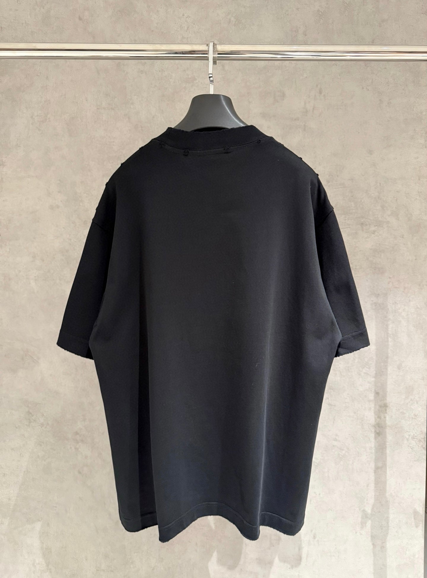 Black short-sleeve T-shirt back view on hanger