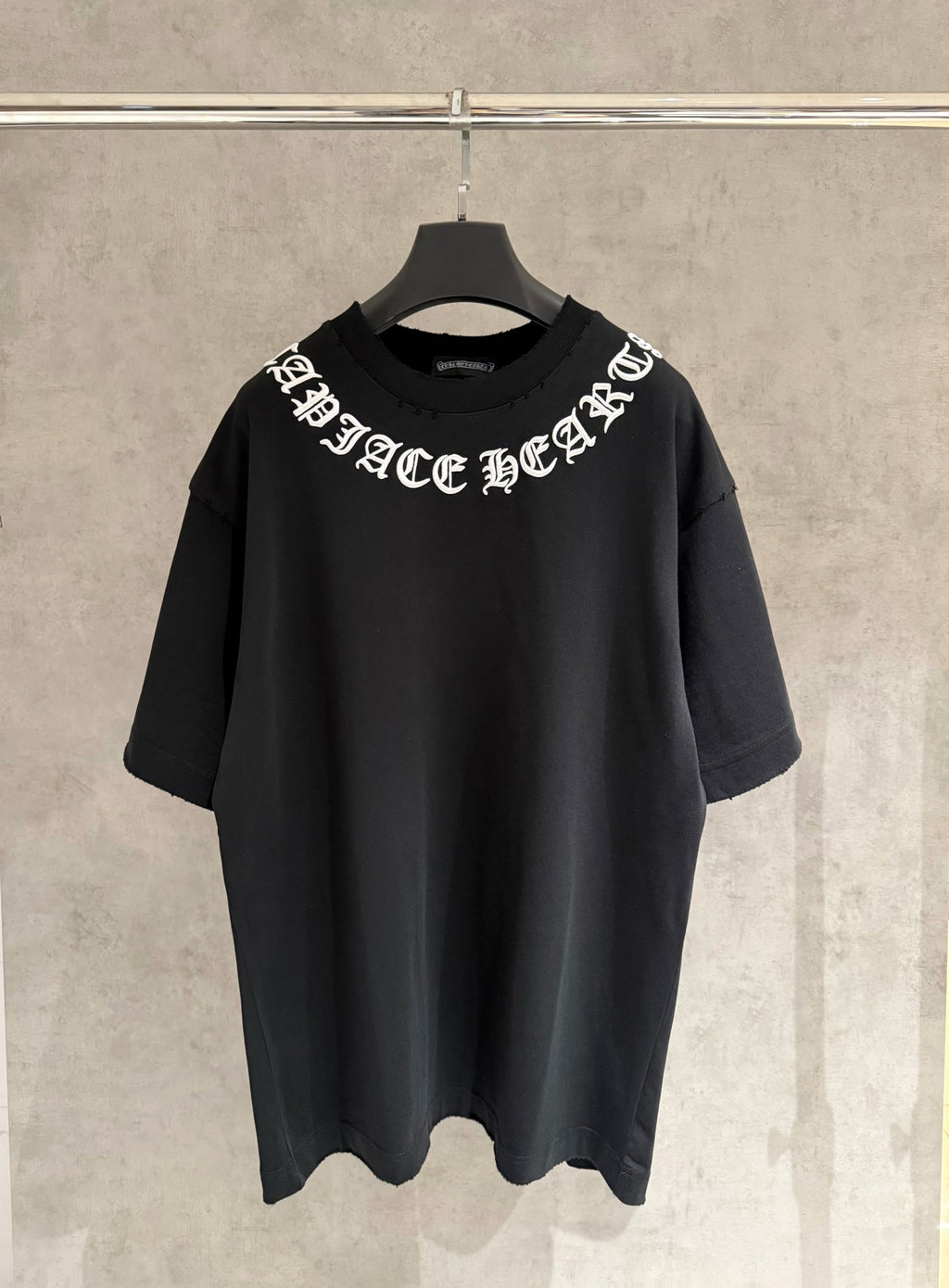 Black short-sleeve T-shirt with white logo text across chest
