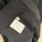 Black T-shirt fabric tag inside seam on sleeve hem
